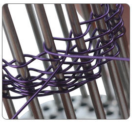 Wire being wrapped around jig pegs